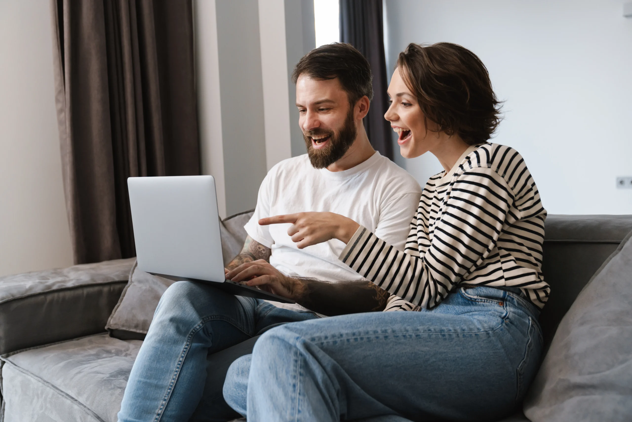Happy young white couple looking at laptop compute 2023 11 27 05 20 49 utc 11zon